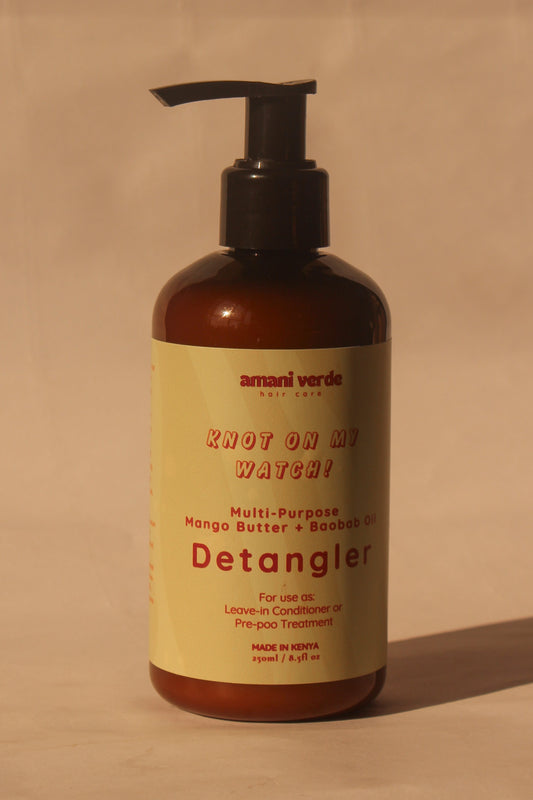 Detangler bottle with pump on a beige background