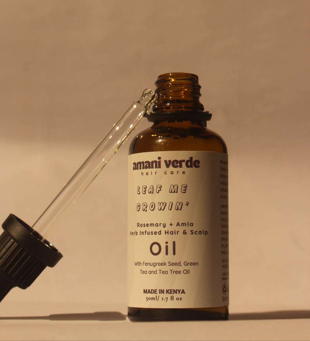 Bottle of Amani Verde oil with dropper on a white background